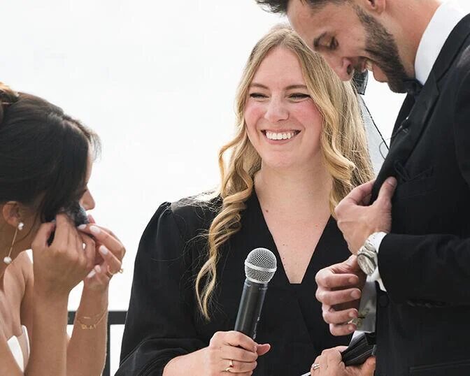 Arielle sharing a laugh with a couple during their ceremony